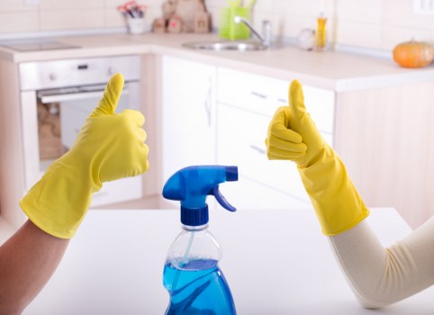 Cleaner preparing a bathroom and kitchen during a turnover clean in SE19