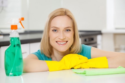 Technician managing a carpet cleaning machine and hose safely