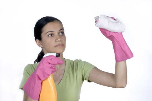 Worker checking wet floor hazards during carpet cleaning
